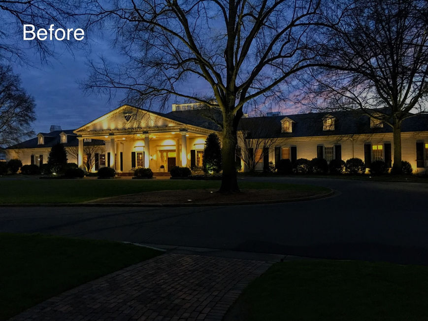 A large, white building with columns is illuminated at dusk, surrounded by trees with bare branches. The word "Before" appears in the top left corner.
